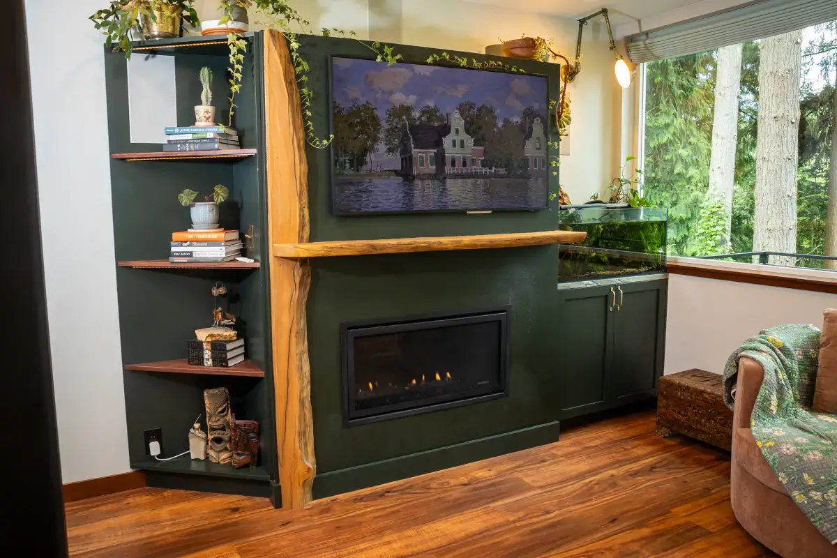 Their custom wood bookcase and entertainment center feature a rough-hewn mantle, wood trim, and a gas fireplace. Their custom wood bookcase and entertainment center feature a rough-hewn mantle, wood trim, and a gas fireplace.