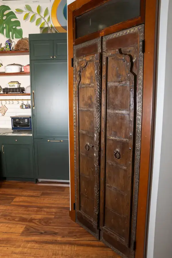 Exquisite, handmade pounded metal and wood doors to a full bathroom. Exquisite, handmade pounded metal and wood doors to a full bathroom.