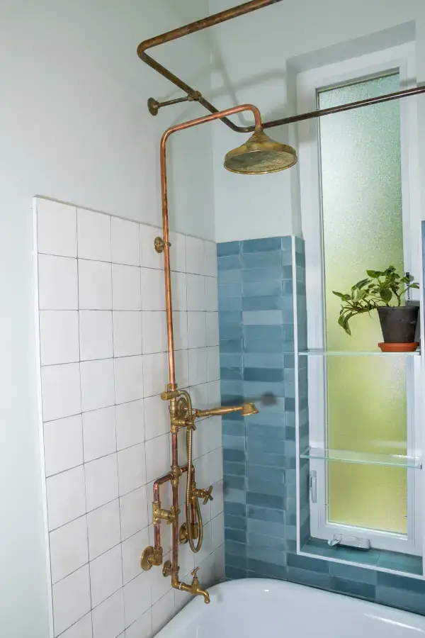 Full bath with custom brass plumbing and shower curtain rods for a claw foot tub, wall tiles, and floor files. Full bath with custom brass plumbing and shower curtain rods for a claw foot tub, wall tiles, and floor files.