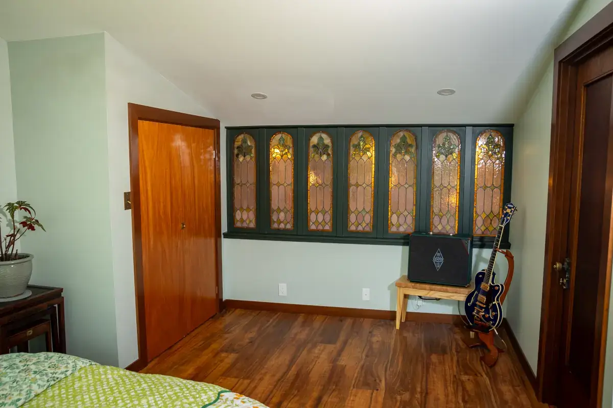 The loft features a row of custom leaded glass windows that face the main/ground floor (into the kitchen). The loft features a row of custom leaded glass windows that face the main/ground floor (into the kitchen).