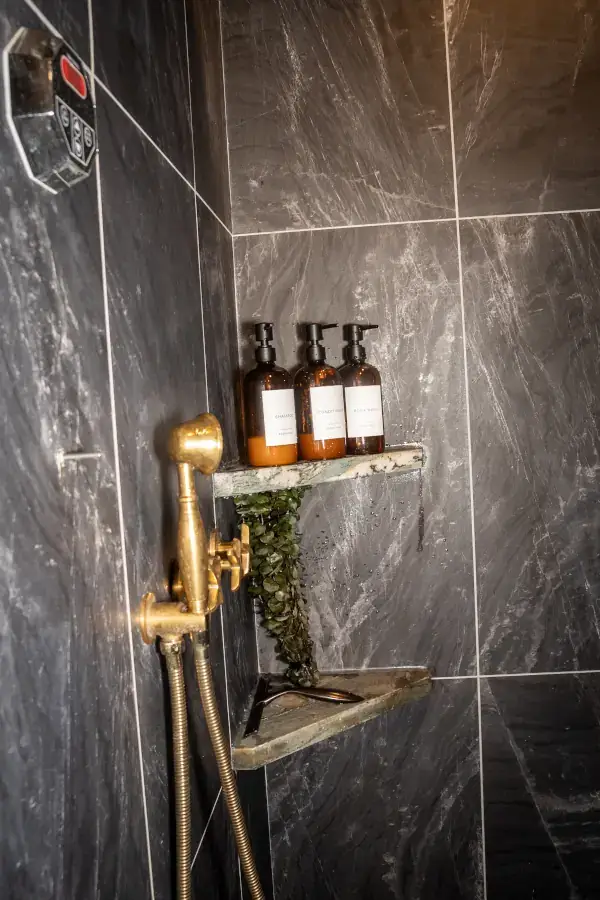 The new master shower has floor-to-ceiling tile, brass plumbing, digital water temperature controls, and built-in shelves and seating. The new master shower has floor-to-ceiling tile, brass plumbing, digital water temperature controls, and built-in shelves and seating.
