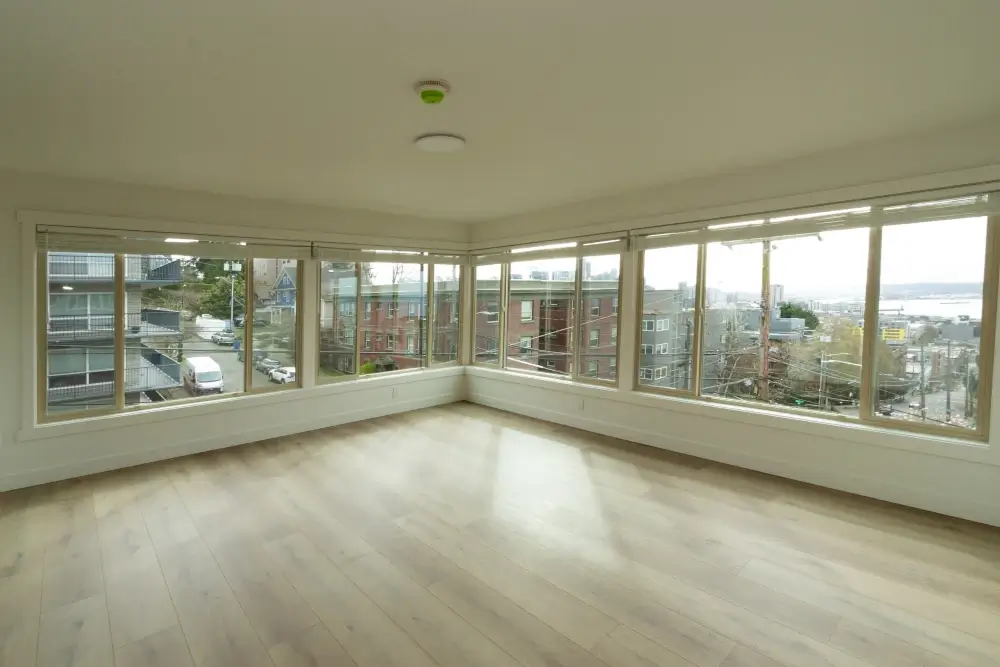 Living room with new flooring, paint, and lighting.